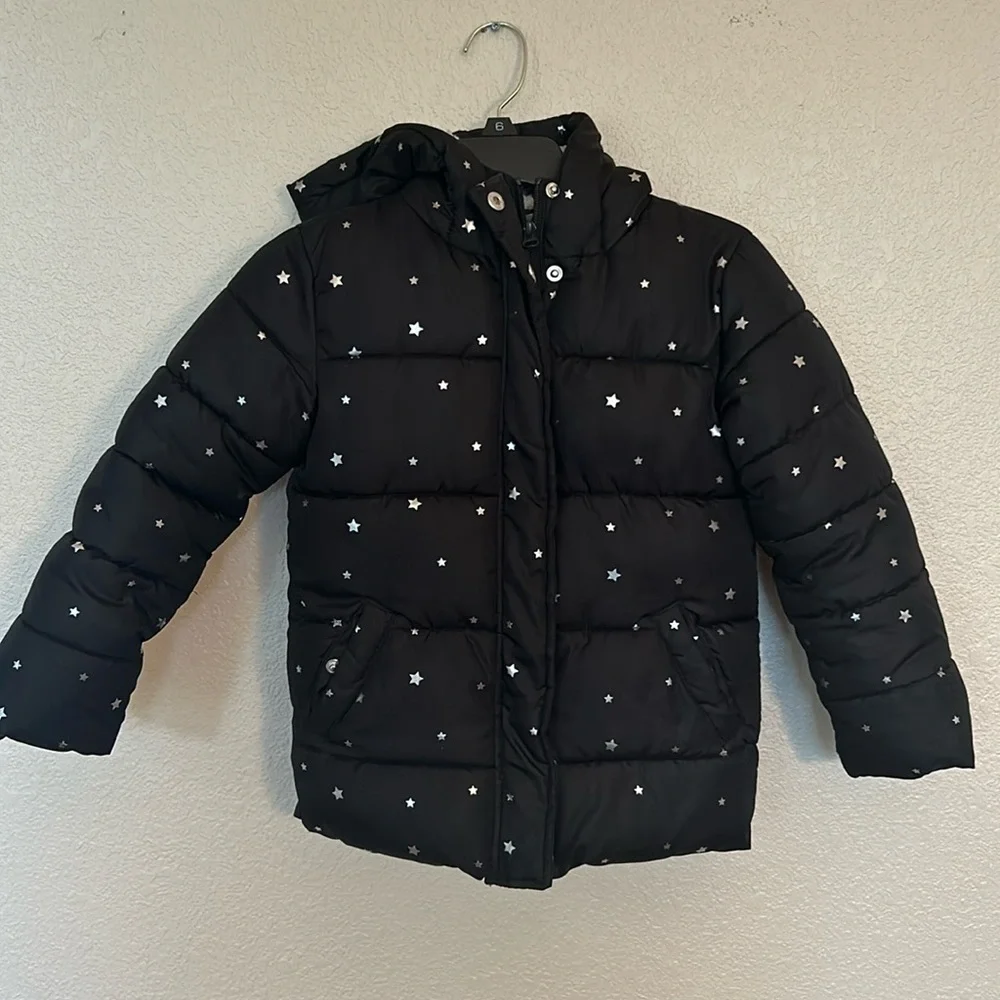 Girls hooded winter coat size XS (4/5) in black with silver stars.